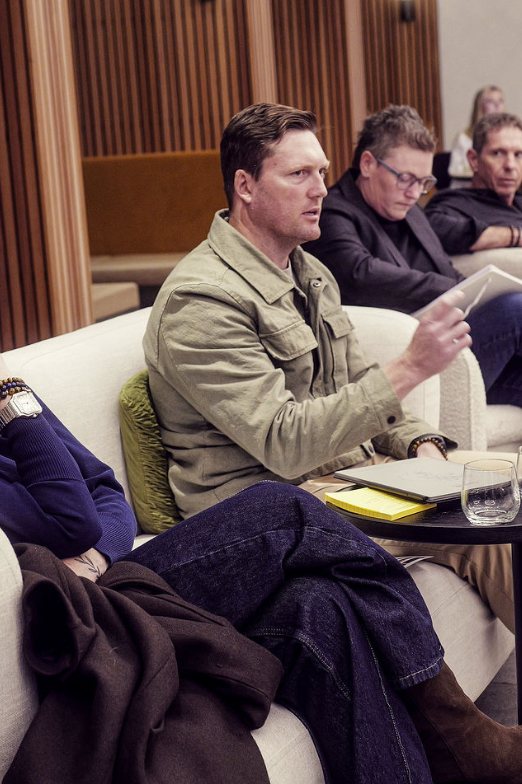 Damian Burstow reading notes during a session
